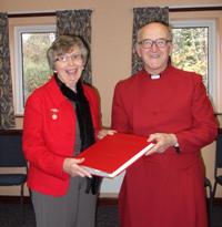 Canon William Bell receives the Architectural Record from Mrs Anne Stevenson of the NADFAS.