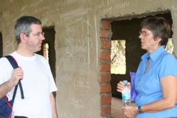 Before the renovations. Archdeacon Stephen Forde chats to CMSI associate Poppy Spens about the plans for a children's ward in this disused building during his January visit to Yei.
