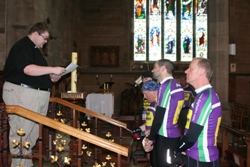 Rev Adrian Dorrian presents St Peters' List of Remembrance and financial pledge to the cyclists.