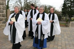 Clergy leave St John the Baptist Church following the Rehallowing Service on March 21.