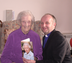 Mrs Annie Thompson shows her 100th birthday card from Her Majest the Queen to the Rt Rev Alan Abernethy, Bishop of Connor.
