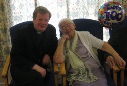 The Rev Nicholas Dark, rector of Magheragall, congratulates Wilma Hutchinson on her 100th birthday.