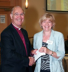Kathleen Rodgers collects Connor MU's first prize for In Touch from Archbishop Harper.