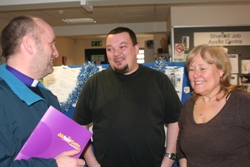 Bishop Abernethy chats with mentors Carson Rankin and Frances Dunseith at the Job Assist centre.