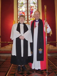Rev Moreen Hutchinson with the Bishop on the chancel steps of St Patrick's Glenarm.