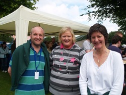 Catherine Simpson, chair of Connor Youth Council, centre with Bishop Alan and his wife Lize at the Summer Madness barbecue.