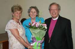 Carol Field presents a bouquet of flowers to Mrs Maureen Poyntz and the Rt Rev Dr Samuel Poyntz (former Bishop of Connor).