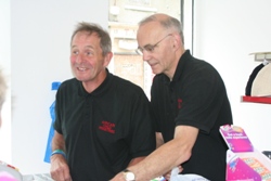 Greenisland parishioner Tony Jones, left, and John Milliken serving customers in the African Child Ministries' charity shop in Carrickfergus.