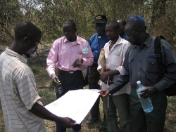 Studying the plans are the Mongo site are the engineer, Archdeacon Stanley Soroba with cap on, William the builder (white shirt) Simon Gaga YVTC Building instructor (grey shirt)