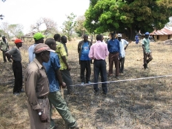 Marking out the site for the classrooms.  Tall man in bright green shirt is Moses Modi, Archdeacon of Longamere and Bishop's Commissary.