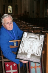 The Dean of Belfast, the Very Rev Dr Houston McKelvey, with a mock-up of the Royal Mail stamp featuring St Anne's Cathedral.
