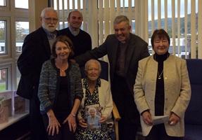Celebrating Sadie’s 100th are, from left: Son-in-law Hugh Gentleman, daughter-in-law Jackie, the Rev Jim Caldwell, Sadie Redpath (with her card from the Queen) Archdeacon Stephen Forde (rector) and daughter Rosemary Gentleman. 