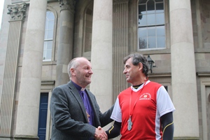 The Bishop of Connor, the Rt Rev Alan Abernethy, congratulates Ken Tate on his marathon run.