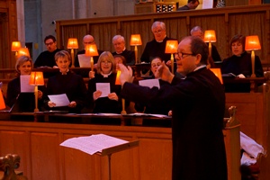 Director Robert Thompson conducts the Priory Singers during the Harry Grindle Memorial Evensong in St Anne’s Cathedral.