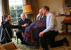 Billy Noble is interviewed on his 106th birthday. With him are Bishop Alan and Billy's son Denis.