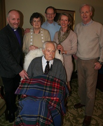 Billy Noble celebrates his 106th birthday with Bishop Alan Abernethy and members of his family.