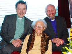 Mrs Zoe Holman celebrates her 100th birthday with the Rev Paul Dundas and Bishop Alan Abernethy.