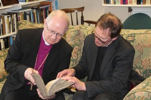 February 2013 - Dean John Mann and Archbishop Richard Clarke browse one of the old books at the official opening of the new library.