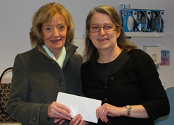 Mrs Maureen Cheevers, wife of the late Canon Alex Cheevers, presents a cheque for £5,500 to Prof McMullan.