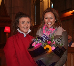 Jennie Carlin, a member of the Cathedral Girls’ Choir, presents a bouquet to special guest Claire McCollum at the Good Samaritans’ Service.