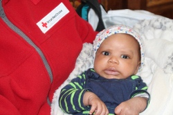 Little Adebobola isn't bothed by all the fuss during the launch of the Red Cross hospital bags project in St Anne's Cathedral.