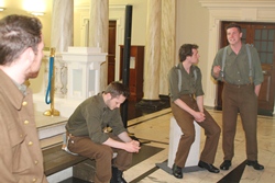 St George's chorister Matt Jeffrey, seated, in character as actors played a scene from 'Medal in the Drawer' at the launch of Lise McGreevy's exhibition.