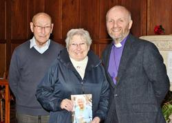 Bishop Alan with Sam and Patricia Letters who were married 60 years ago in St Patrick's. Patricia is holding the card from Her Majesty the Queen. 