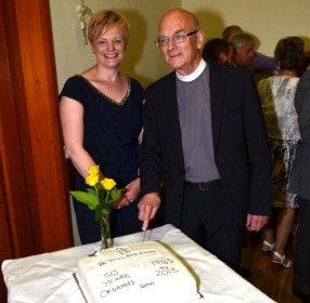 Rev John Pickering cuts the 50th anniversary or ordination cake with his daughter Sarah.