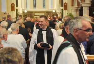 The Rev Jason Kernohan meets some members of the congregation during the recessional hymn.