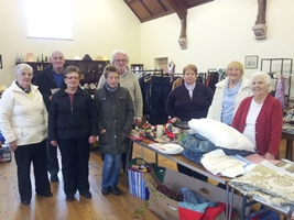 Volunteers and customers in the charity shop in St Ninian's parish hall.