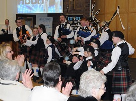 The Fittis family who are all involved in 8th Carrick BB piping onstage during the concert.