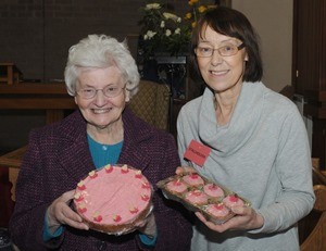 Isabel Kirkwood and Noreen Kavanagh at the cake stall at a community event and fundraiser at Derryvolgie Parish Church.