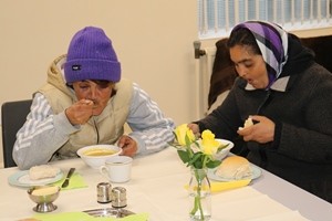 Two Romanian ladies whose home is on the streets of Belfast tuck into their lunch.
