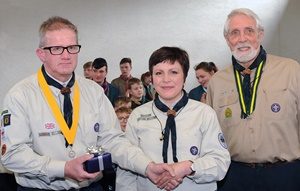 Incoming District Commissioner Audrey Morrow pictured presenting a retirement gift to outgoing District Commissioner Noel Irwin in recognition of his exemplary service to scouting in the Lisburn area.  Looking on is Billy Mawhinney (District President).