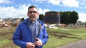 The Rev William Orr beside the Ballycraigy bonfire while it was still being built.