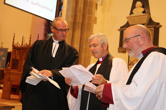 Canon William Taggart, Archdeacon Stephen Ford and new Canon Derek Kerr making final preparations before the installation service.