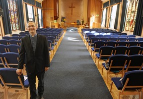 The rector, the Rev Stephen McElhinney with new church chairs which were dedicated by The Rt Rev Alan Abernethy (Bishop of Connor).