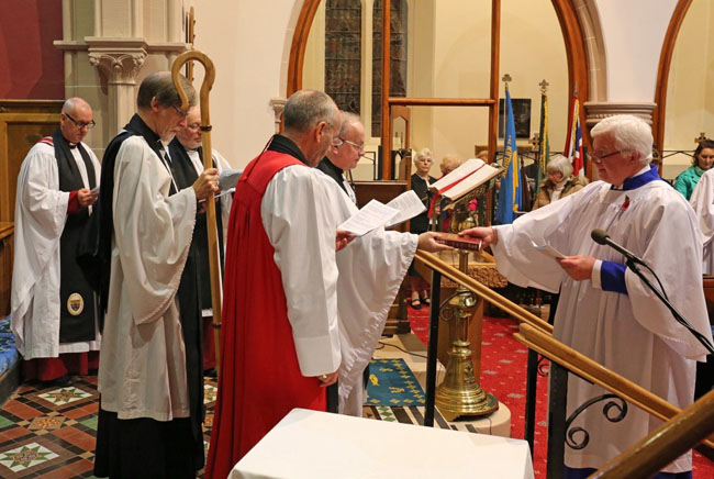 Nigel Cinnamon, Parish Nominator, presents the Rev Canon David Humphries with a Bible during the institution service in Kilbride. Photo: David Holmes.