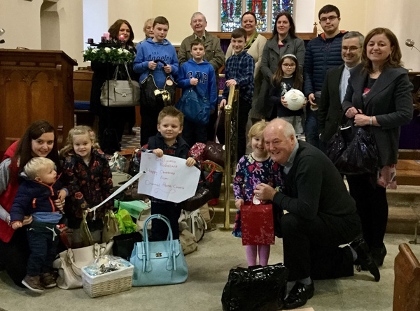The Rev Trevor Kelly and Mrs Aurelia Kelly with children and parishioners of a Drummaul Parish Church.
