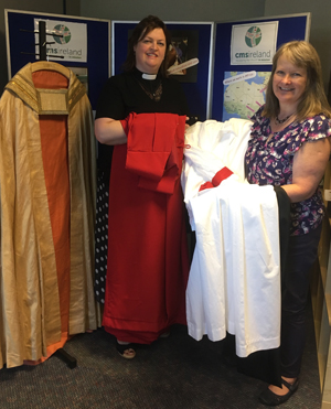 The Rev Louise Stewart gives the handmade robes to Jenny Smyth, CMSI Mission Director.