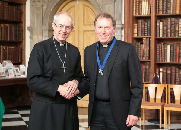 Former Dean receives Lambeth Cross from Archbishop of Canterbury