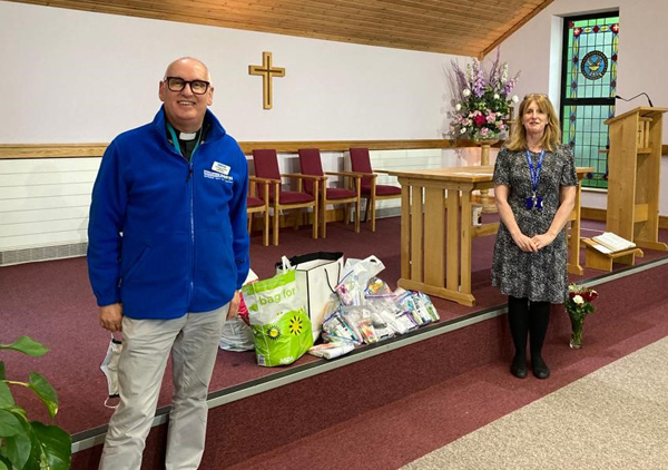 Archdeacon Stephen McBride, Connor MU Chaplain, delivers wash bags from Connor MU members to Hospital Chaplain Sanna Mallon in the church within Musgrave Park Hospital. 