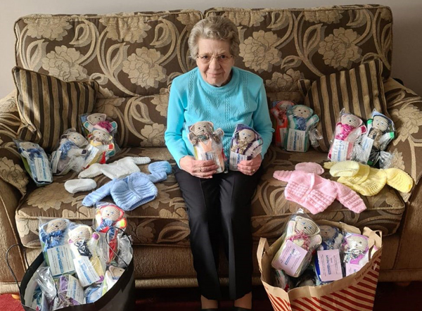 Margaret Marshall surrounded by the 160 teddies she knit for Baby Basics Belfast.