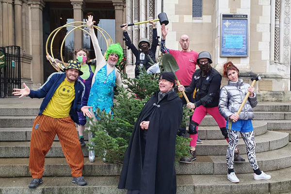 Artistes from the Tumble Circus in Writers' Square with Black Santa a colourful merry Christmas.